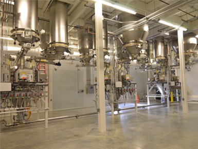Stainless steel hoppers and ingredient handling equipment on the King's Hawaiian plant floor