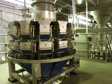 A multihead weigher feeding Natura's packaging line